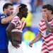 Bosnia's Sead Kolasinac pats United States' Folarin Balogun on the head as United States' Christian Pulisic stands by after receiving a red card.