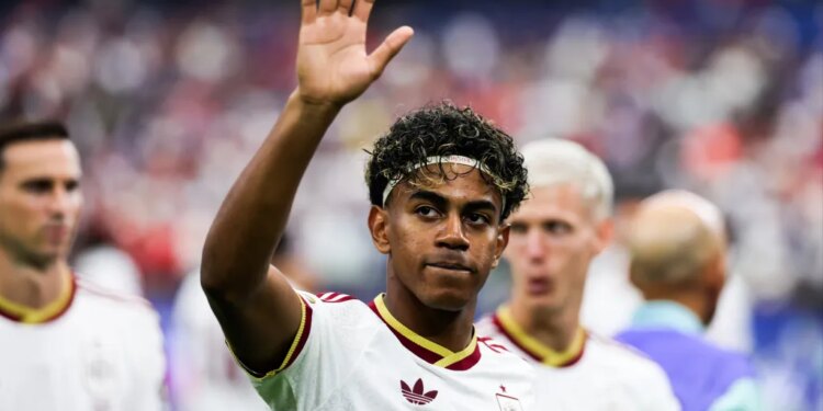 Lamine Yamal waves to the crowd at the FIFA World Cup semifinal match between France and Spain.