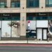 The exterior of Tatte Bakery & Cafe on the Upper East Side, featuring window displays of floral arrangements, a coffee, and a blueberry tart.