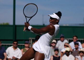 Venus Williams hitting a return at Wimbledon.