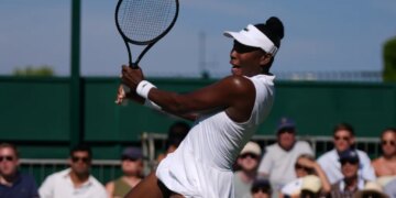 Venus Williams hitting a return at Wimbledon.