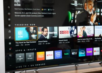 The Vizio Mini LED Quantum display the Vizio OS home page, on a wooden credenza.