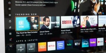The Vizio Mini LED Quantum display the Vizio OS home page, on a wooden credenza.