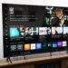 The Vizio Mini LED Quantum display the Vizio OS home page, on a wooden credenza.