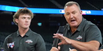 Jim Thome speaking at the MLB baseball combine with Landon Thome listening.
