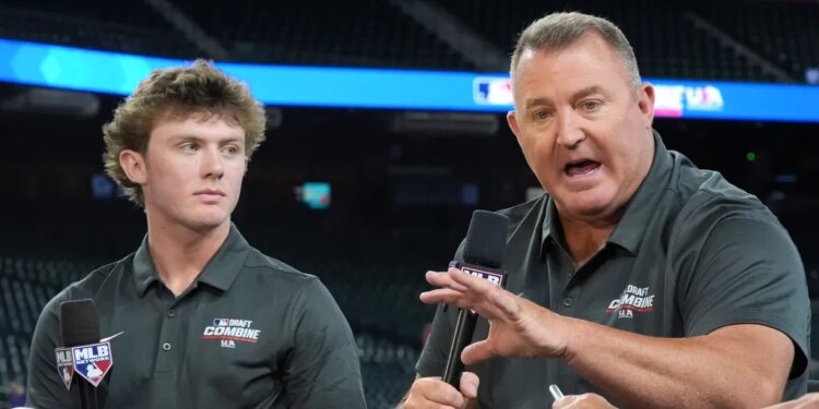 Jim Thome speaking at the MLB baseball combine with Landon Thome listening.