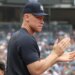 Aaron Judge clapping in the dugout during a Yankees-Twins game.