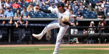 New York Yankees pitcher Carlos Lagrange #84 mid-pitch in the 1st inning.