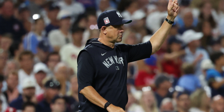 New York Yankees manager Aaron Boone signals for a pitching change.