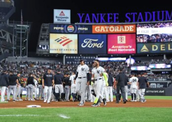 New York Yankees shortstop José Caballero #72 is walked back to the dugout after a scuffle with Pittsburgh Pirates pitcher Dennis Santana #60 and New York Yankees second baseman Jazz Chisholm Jr. #13 during the 8th inning at Yankee Stadium.