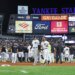 New York Yankees shortstop José Caballero #72 is walked back to the dugout after a scuffle with Pittsburgh Pirates pitcher Dennis Santana #60 and New York Yankees second baseman Jazz Chisholm Jr. #13 during the 8th inning at Yankee Stadium.