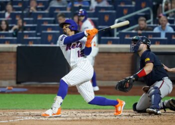 New York Mets shortstop Francisco Lindor (12) hits a two-run home run against the Atlanta Braves.