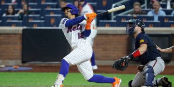 New York Mets shortstop Francisco Lindor (12) hits a two-run home run against the Atlanta Braves.